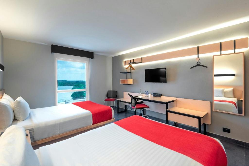 Letto o letti in una camera di City Express by Marriott Tuxpan