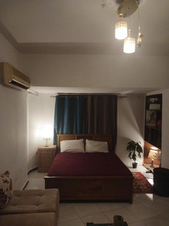 a bedroom with a bed and a couch at 7 stars Zamalek in Cairo