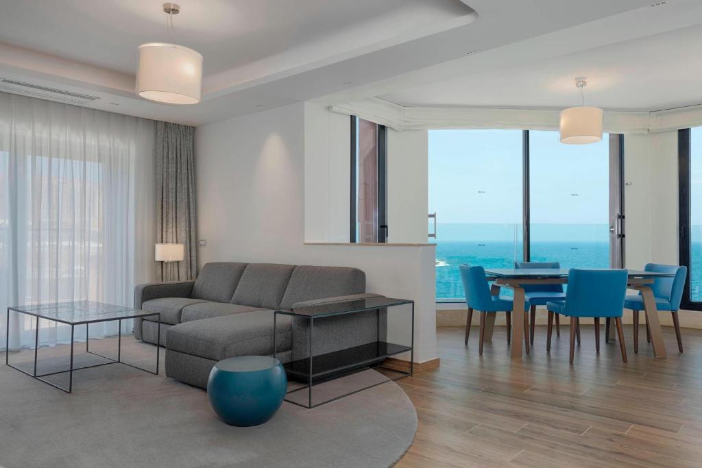 a living room with a couch and a table at The Westin Dragonara Resort, Malta in St. Julianʼs