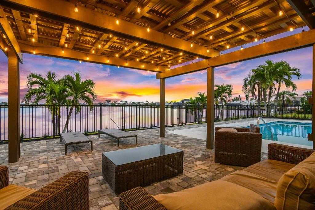 an outdoor patio with a view of a pool at The Waterfront Fishing Retreat in Cape Coral