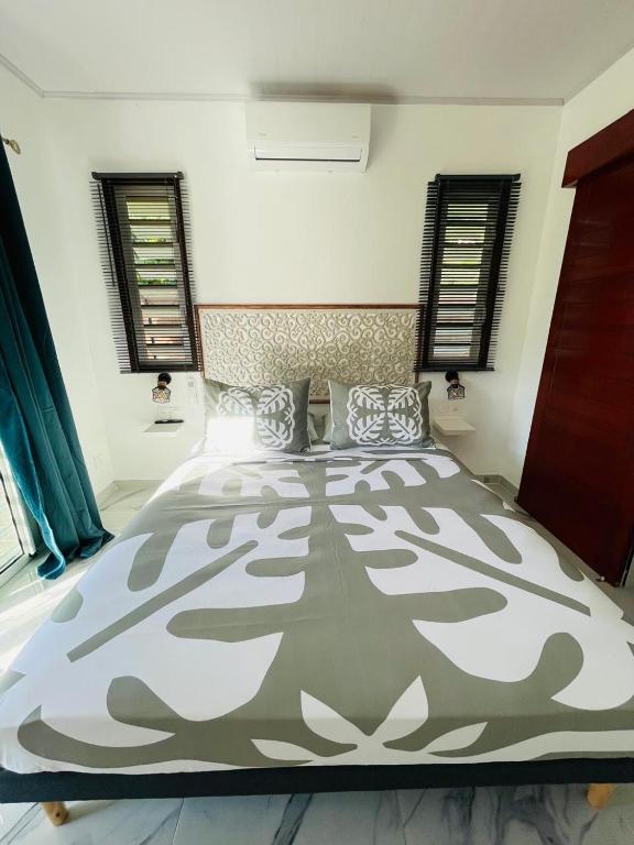 a bedroom with a large bed in a room at Fare Moorea in Moorea