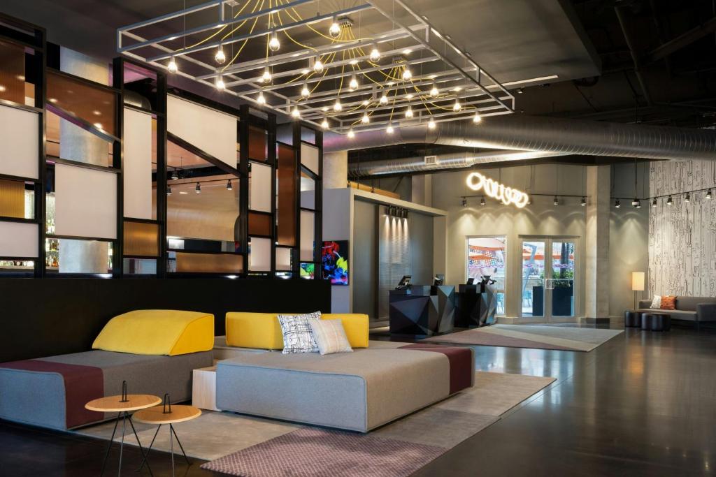 a lobby with a couch and tables in a store at Aloft Sarasota in Sarasota