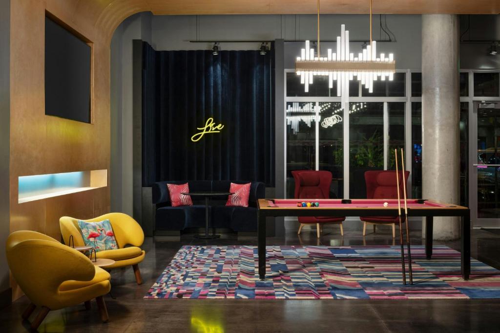 a dining room with a ping pong table and chairs at Aloft Sarasota in Sarasota