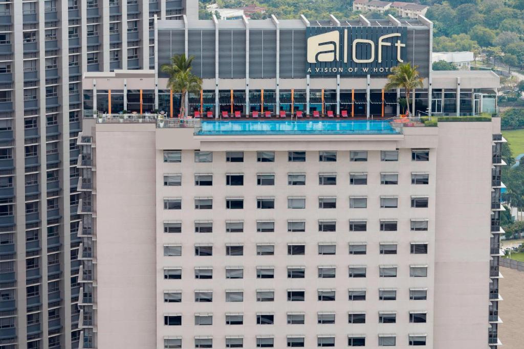 an office building with a pool on top of it at Aloft Kuala Lumpur Sentral in Kuala Lumpur