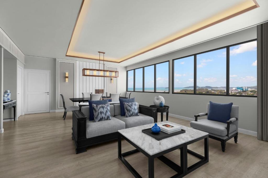 a living room with a couch and a table at Courtyard by Marriott Phuket Town in Phuket Town