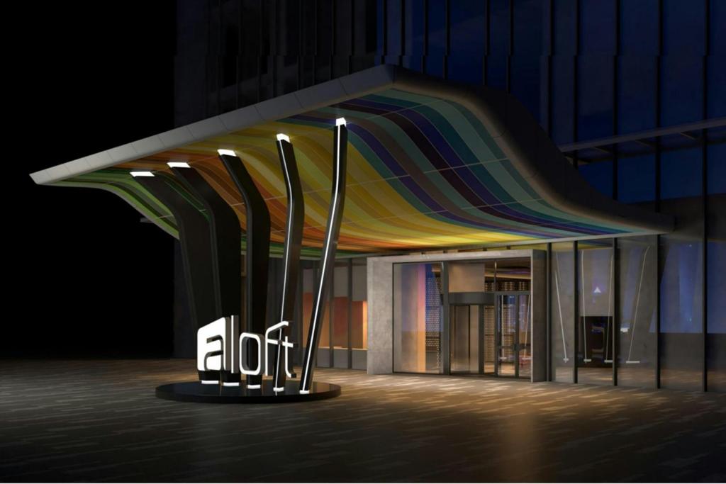a building with a colorful umbrella on display in front of it at Aloft by Marriott Shijiazhuang in Shijiazhuang