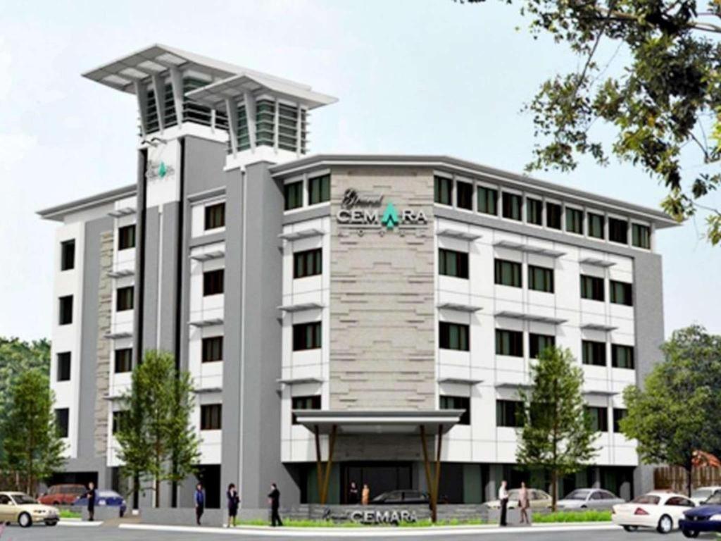 a large white building with people in front of it at Grand Cemara Hotel in Jakarta