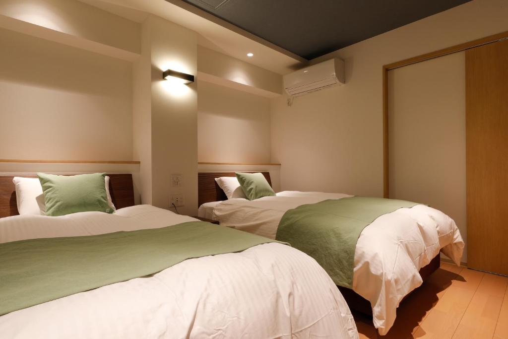 Postel nebo postele na pokoji v ubytování Yunogo Grand Hotel