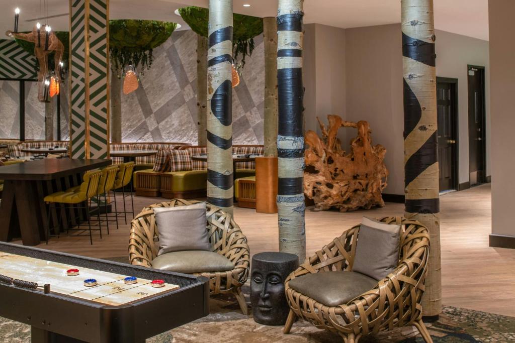 a room with a pool table and some chairs at Hotel Paradox, Autograph Collection in Santa Cruz