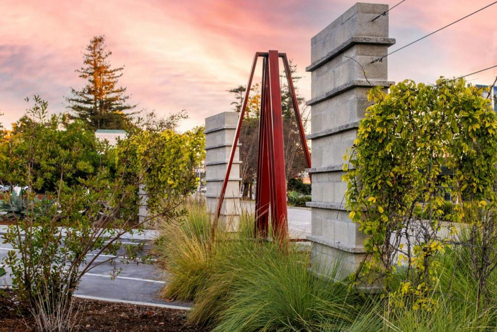 a garden with a red slide in the middle at Hotel Paradox, Autograph Collection in Santa Cruz