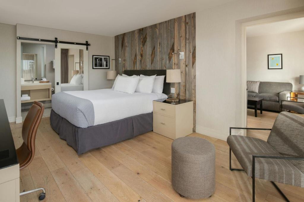 a hotel room with a bed and a living room at Hotel Paradox, Autograph Collection in Santa Cruz