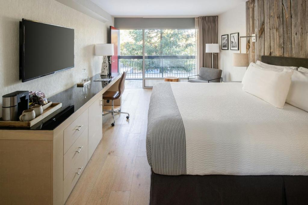 a hotel room with a large bed and a television at Hotel Paradox, Autograph Collection in Santa Cruz