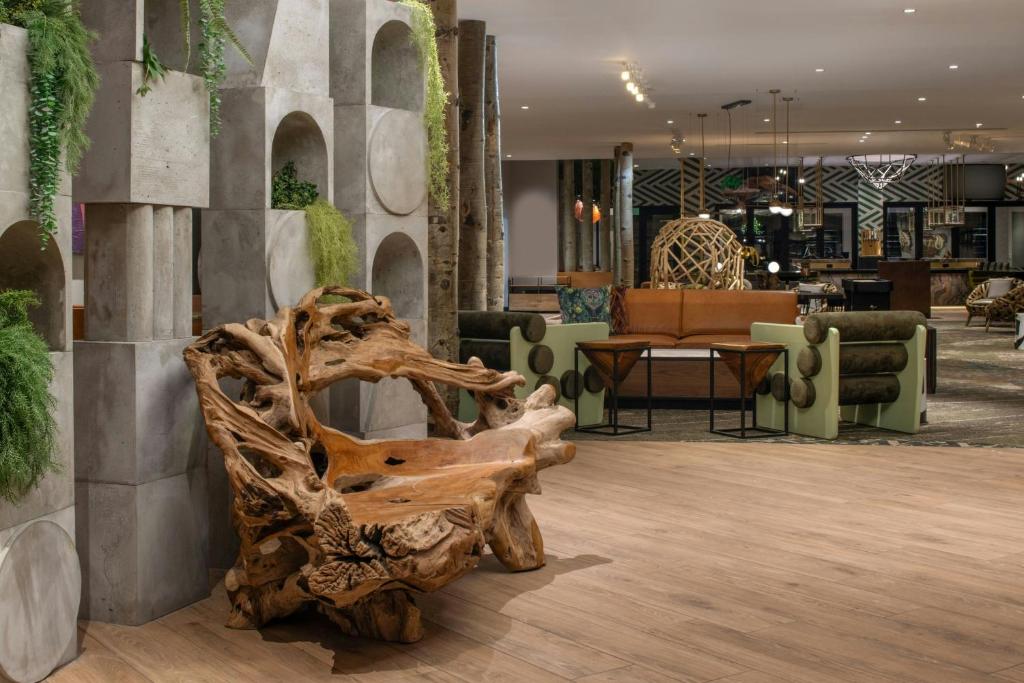 a tree stump sitting in the middle of a lobby at Hotel Paradox, Autograph Collection in Santa Cruz