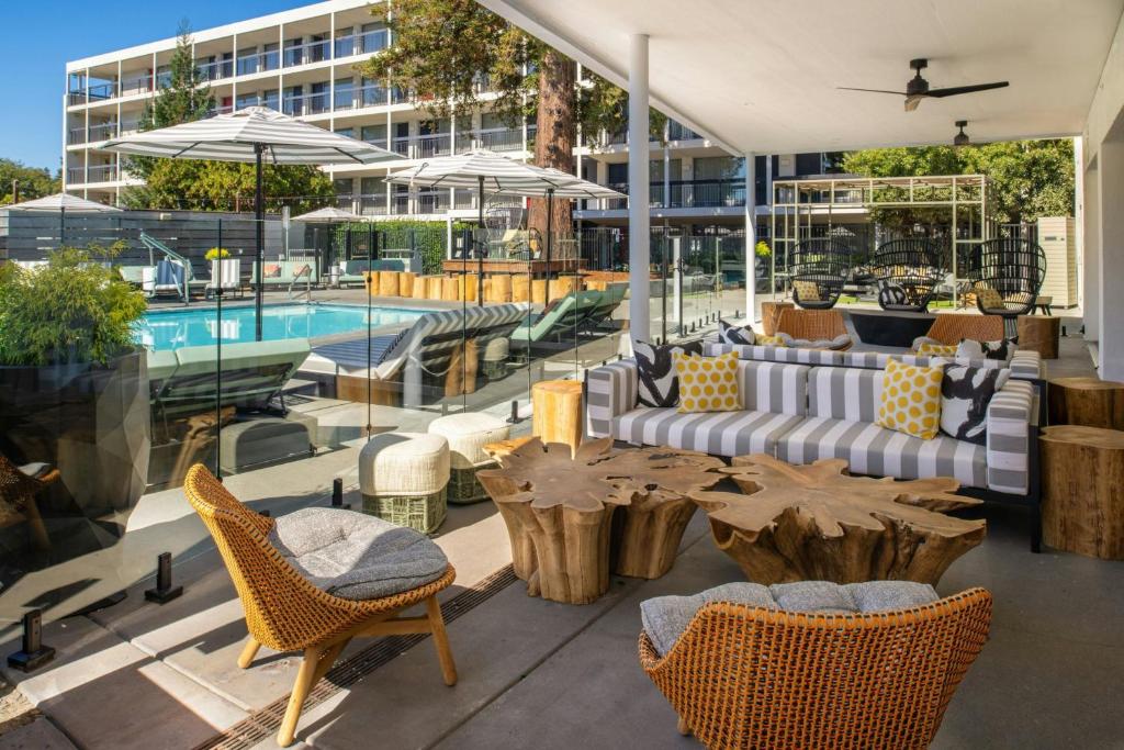 a patio with a table and chairs and a pool at Hotel Paradox, Autograph Collection in Santa Cruz