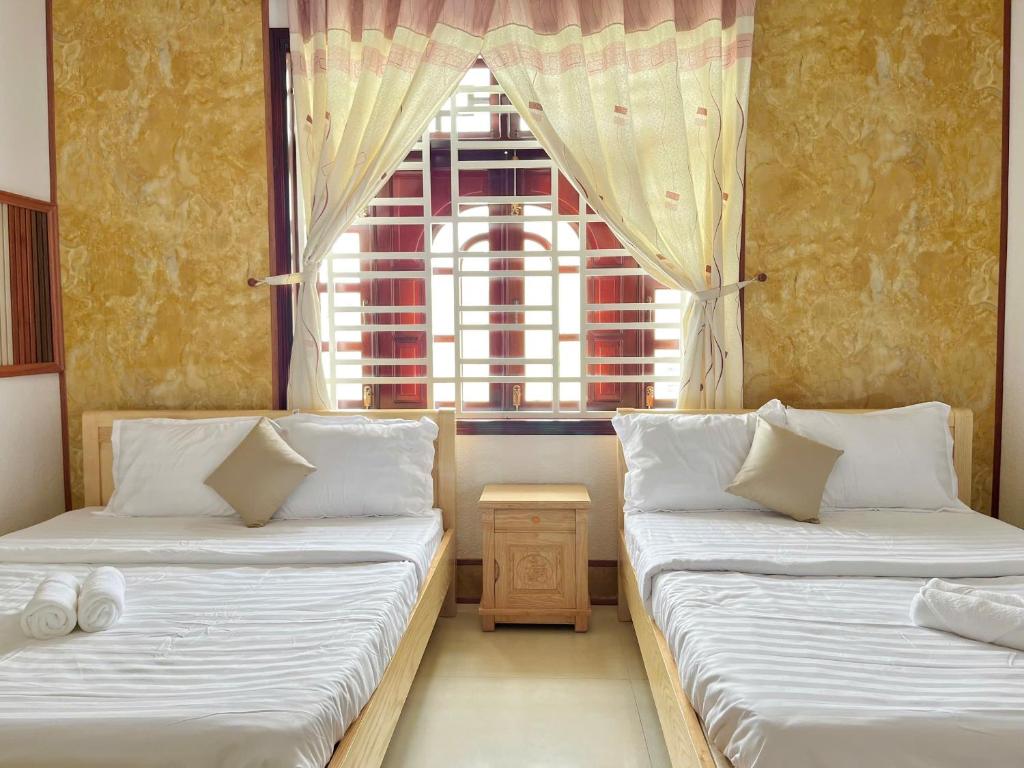 Postel nebo postele na pokoji v ubytování Mekong INN
