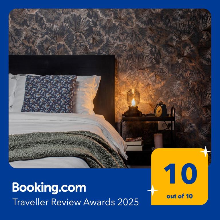 a bedroom with a bed with a yellow sign that says travel review awards at Old Town by Humpback in Craiova