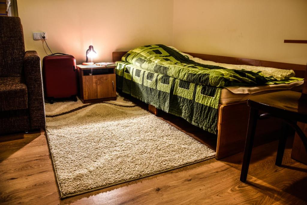 a bedroom with a bed and a table and a mirror at Motel Na Skarpie in Bielsko-Biała