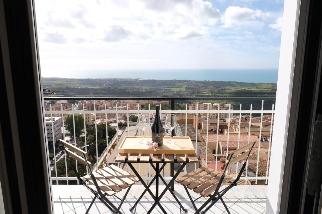 a view from a balcony with a table and chairs at Temples and Sea view Apartment in Agrigento