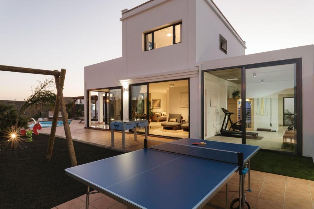 a house with a ping pong table in front of it at Villa Amaranta in Yaiza