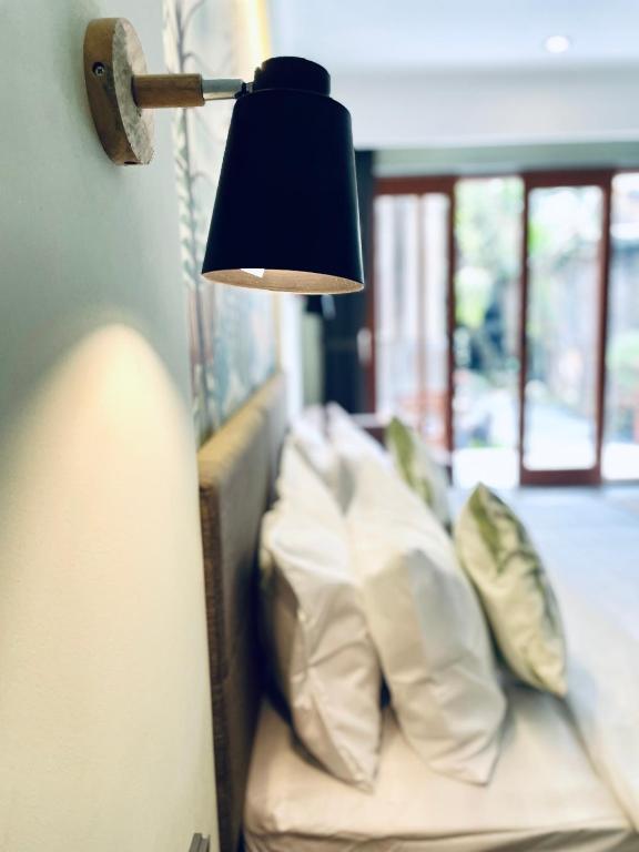 Postel nebo postele na pokoji v ubytování Rumah Baris Ubud
