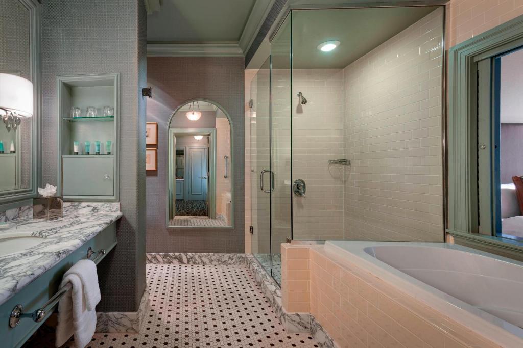a large bathroom with a tub and a shower at Hotel ICON, Autograph Collection in Houston