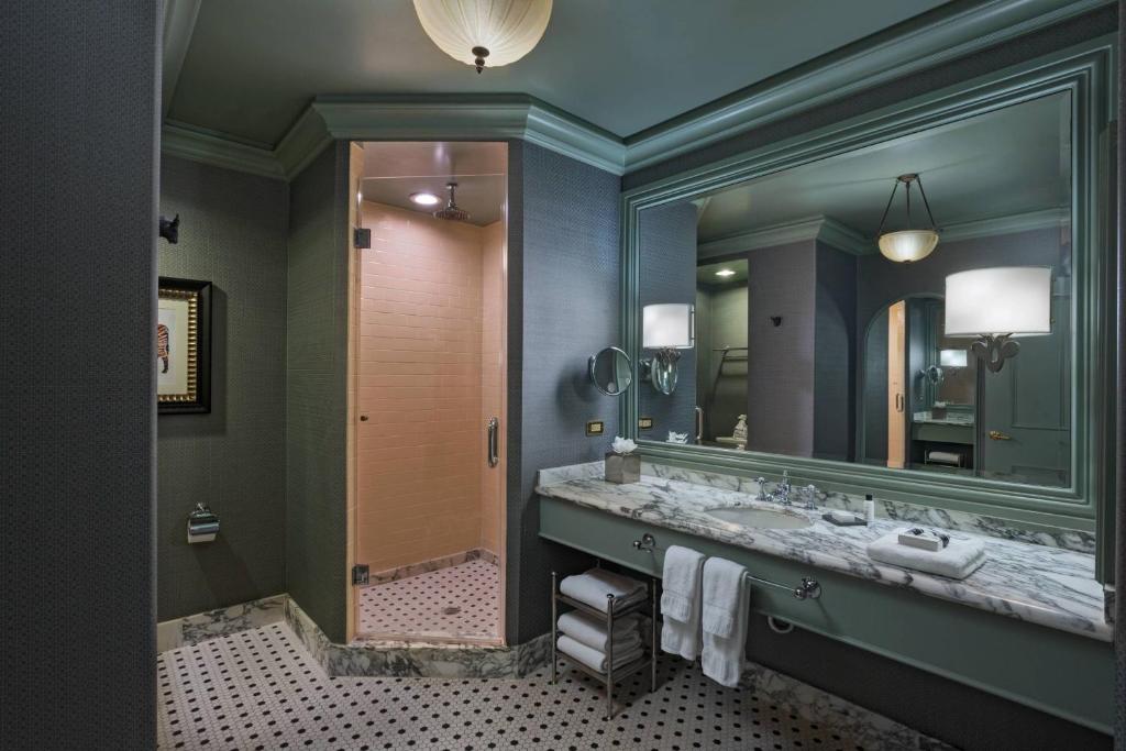 a bathroom with two sinks and a large mirror at Hotel ICON, Autograph Collection in Houston