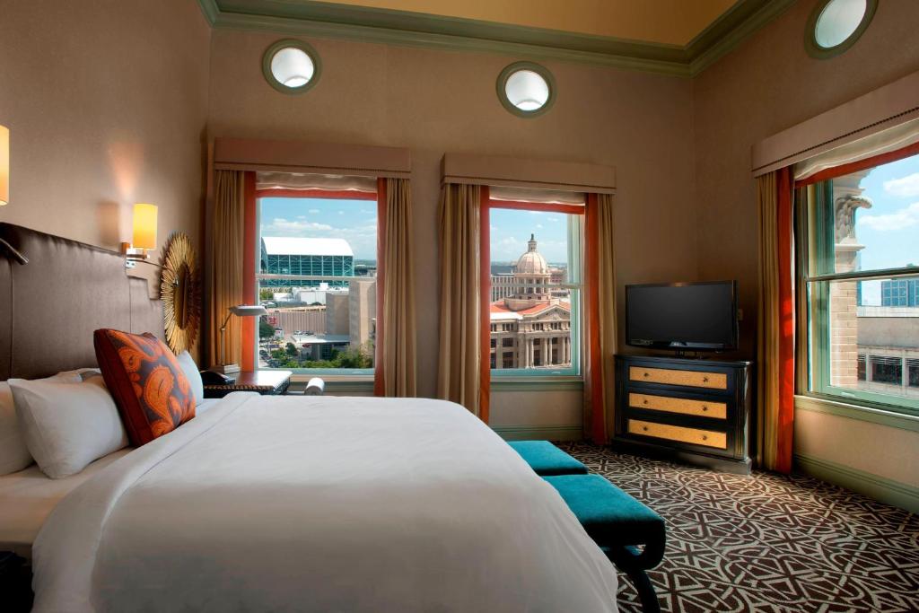 a hotel room with a large bed and a television at Hotel ICON, Autograph Collection in Houston