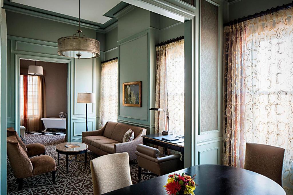 a living room with a table and chairs at Hotel ICON, Autograph Collection in Houston