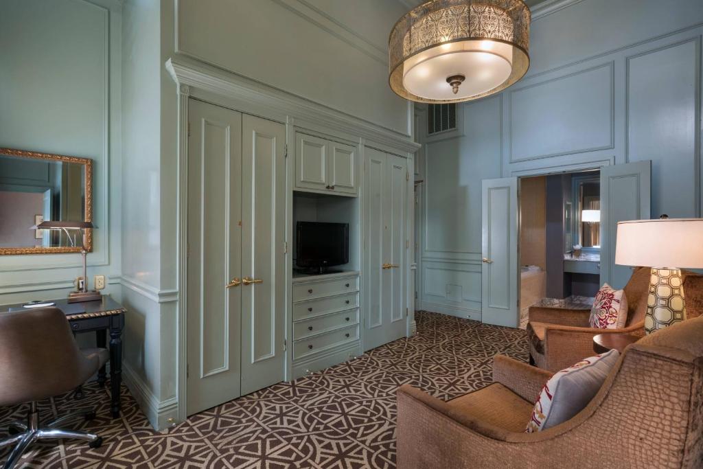 a living room with a couch and a television at Hotel ICON, Autograph Collection in Houston