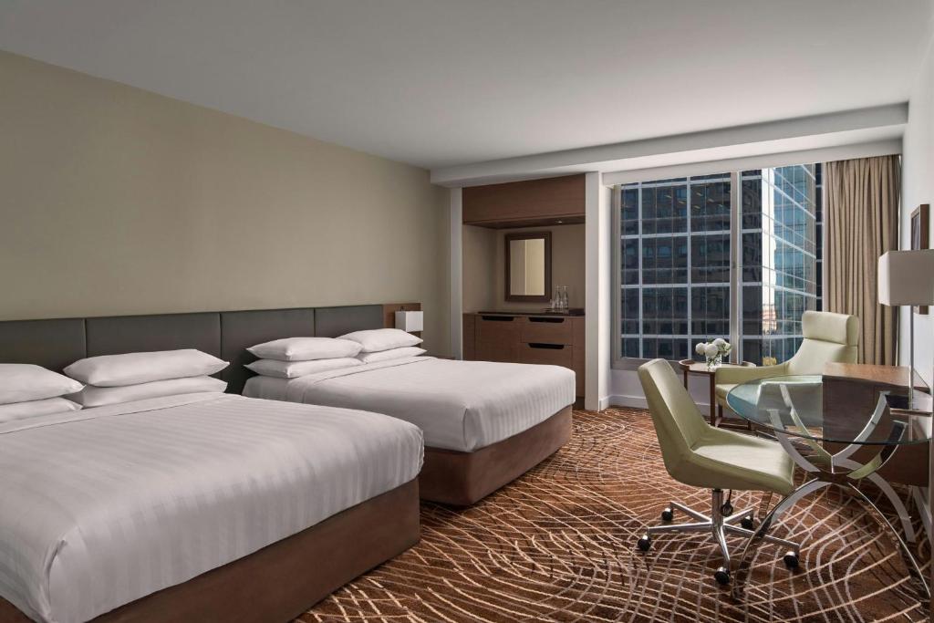 Postel nebo postele na pokoji v ubytování Melbourne Marriott Hotel