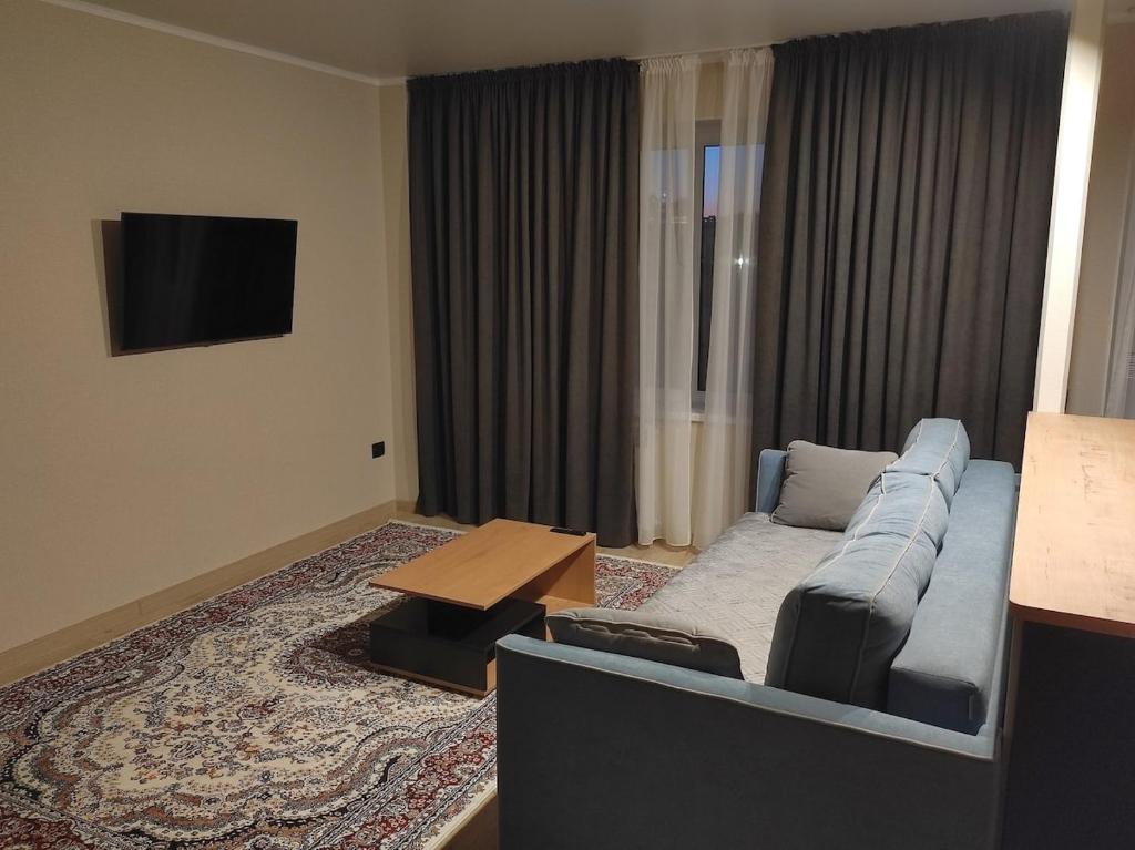 a living room with a couch and a table at Apartment for rent number 3 in Aktau