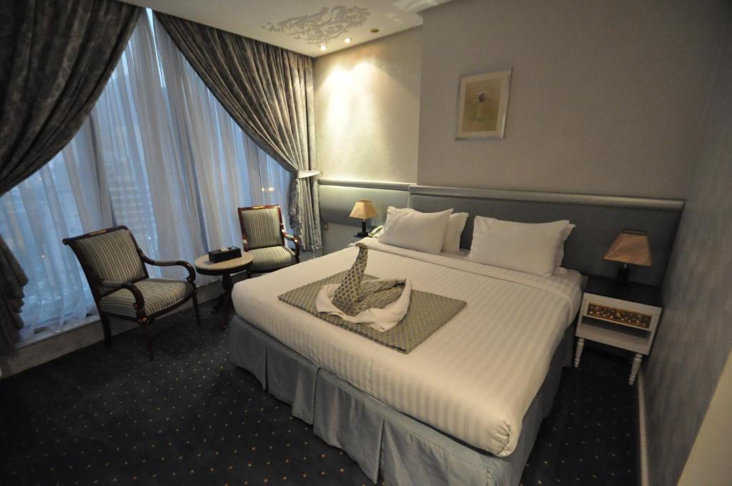 Postel nebo postele na pokoji v ubytování Montana Al Azizia Hotel