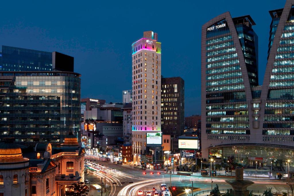 a city skyline with tall buildings and traffic at night at Aloft Seoul Myeongdong in Seoul