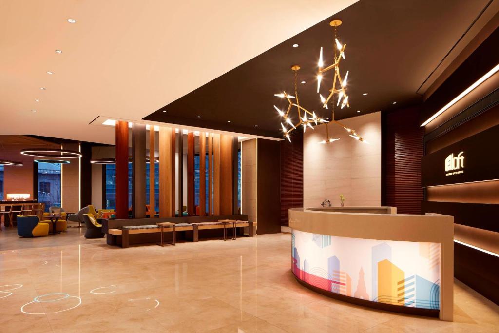 a lobby of a hotel with a waiting area at Aloft Seoul Myeongdong in Seoul