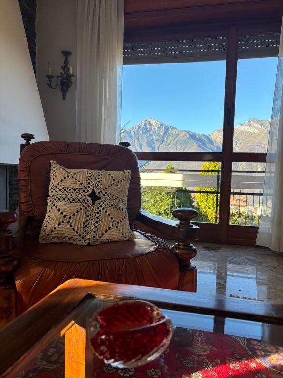 a living room with a couch and a large window at Casa Rosa in Cassina Valsassina