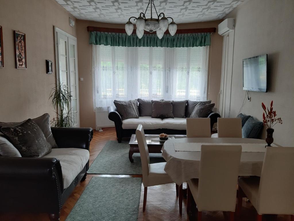 a living room with a couch and a table at Apartman Veiger4 in Siófok