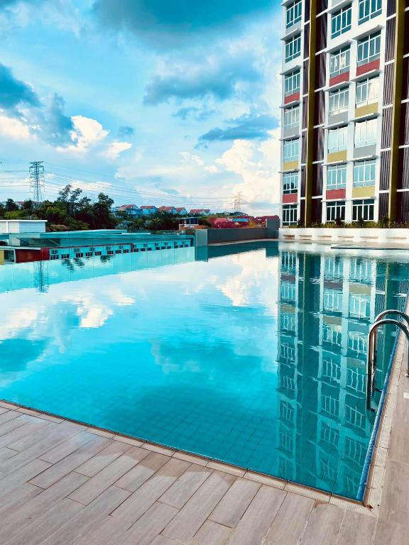 a swimming pool in front of a building at FUMY Homestay in Kuantan