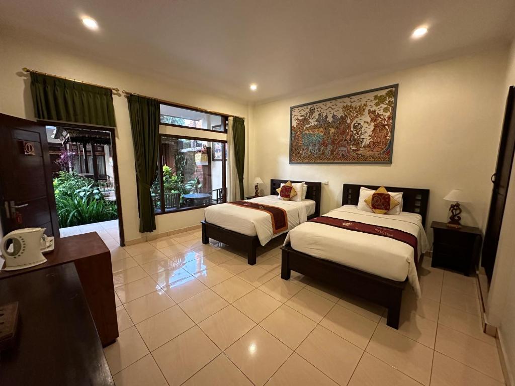 Postel nebo postele na pokoji v ubytování Brata Inn Ubud