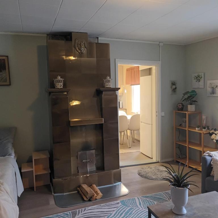 a room with a book shelf in the middle of a room at Askaistentie 29 in Turku