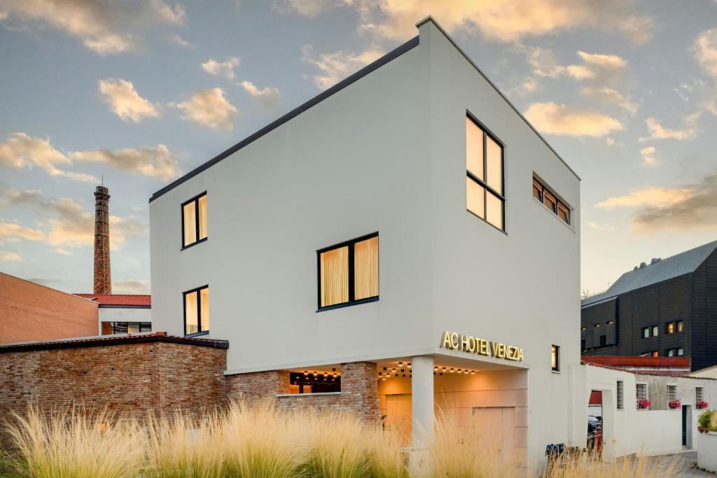 a white house with a black roof at AC Hotel Venezia by Marriott in Venice