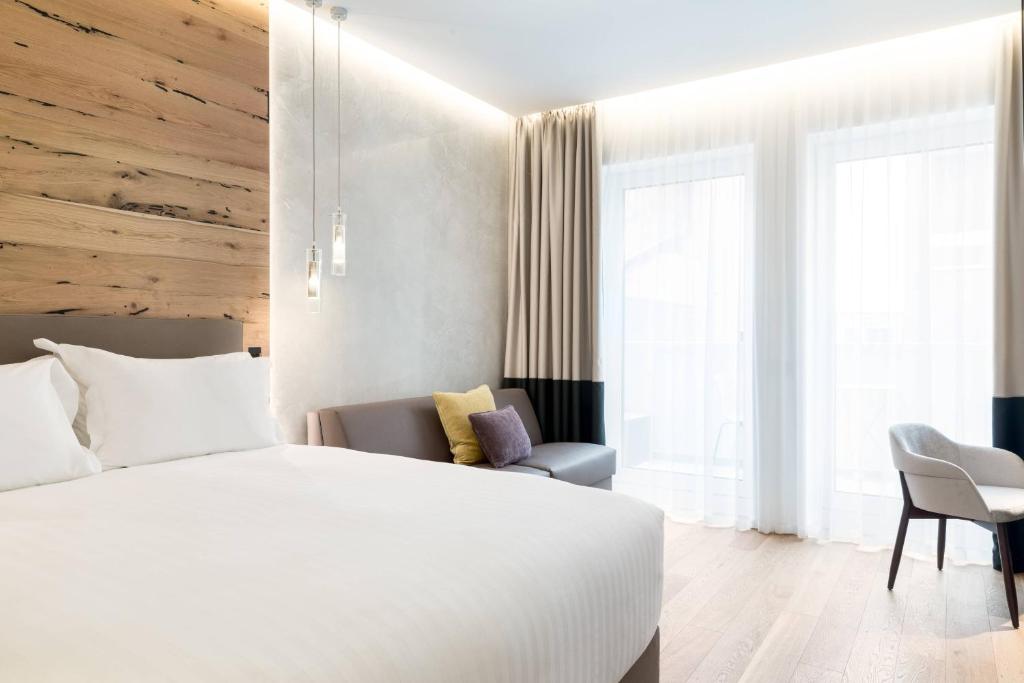 a hotel room with a bed and a chair at AC Hotel Venezia by Marriott in Venice