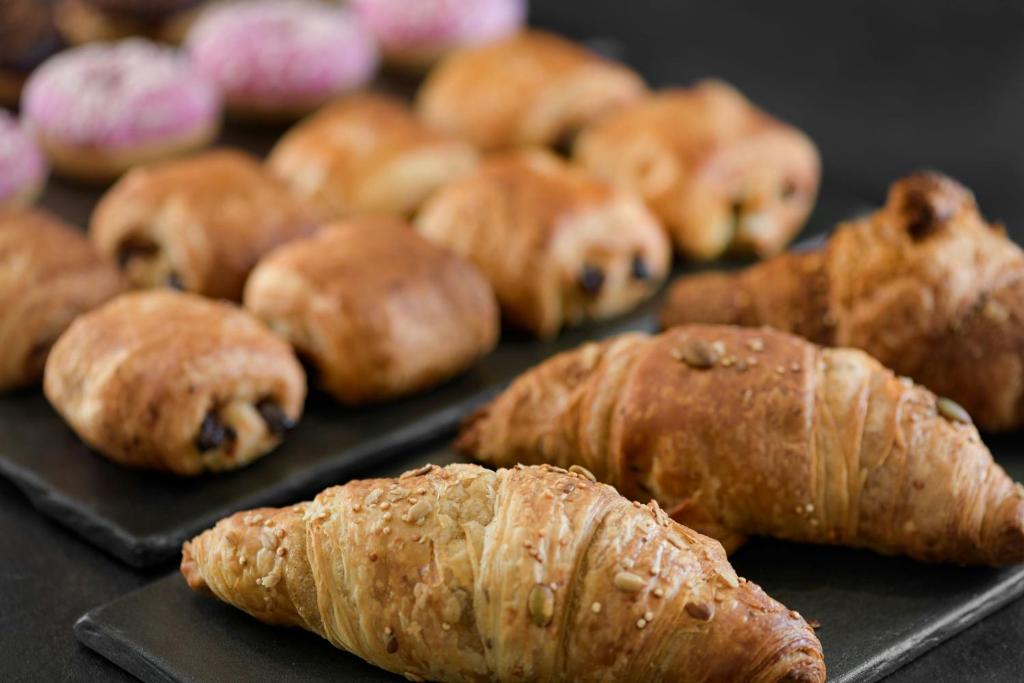 a bunch of pastries sitting on a tray at AC Hotel Venezia by Marriott in Venice