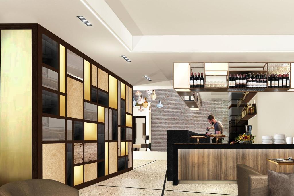 a man standing at a bar in a restaurant at AC Hotel Venezia by Marriott in Venice