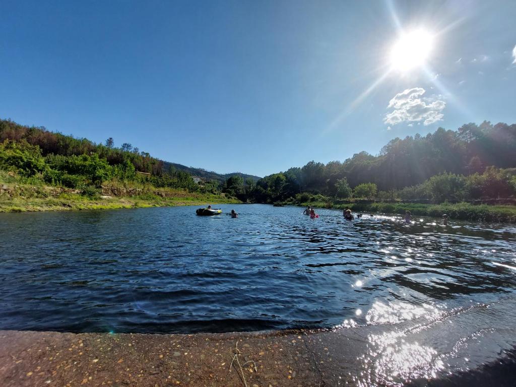 a group of people swimming in a river at El Descanso de Las Hurdes in Sauceda
