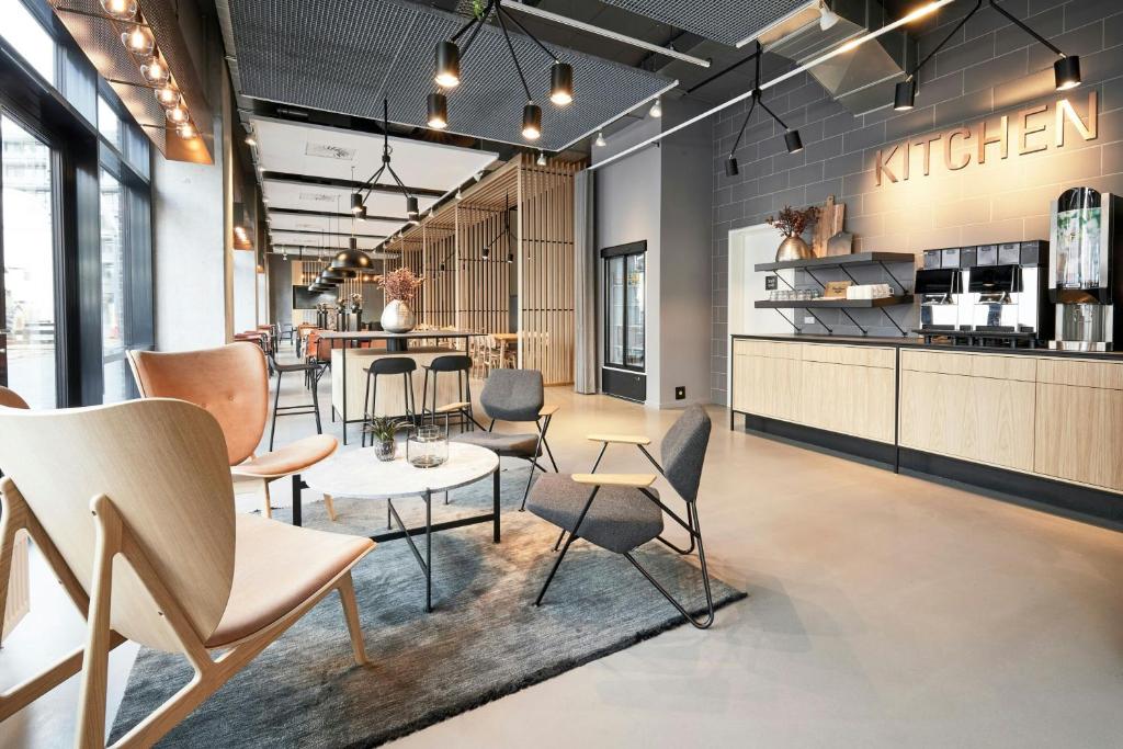 a waiting room with chairs and a table at Four Points Flex by Sheraton Aalborg in Aalborg