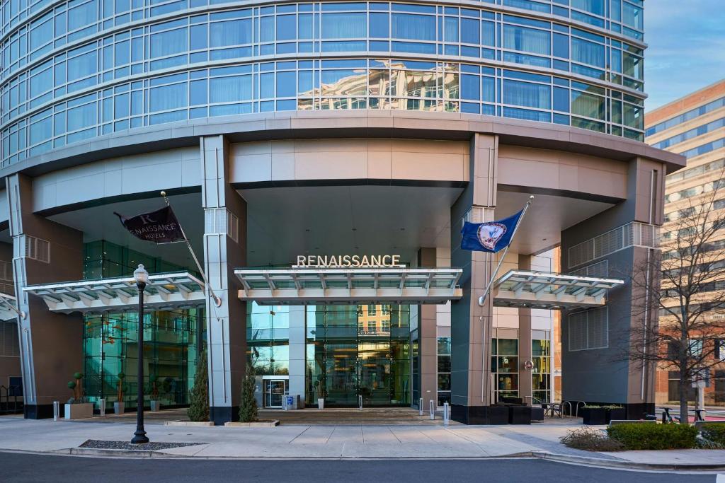 a large building with a flag in front of it at Renaissance Arlington Capital View Hotel in Arlington