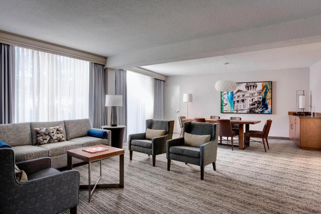a living room with a couch and chairs and a table at Houston Airport Marriott at George Bush Intercontinental in Houston