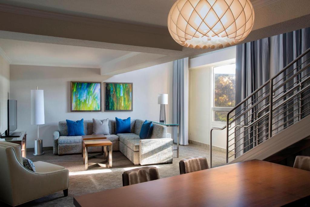 a living room with a couch and a table at Houston Airport Marriott at George Bush Intercontinental in Houston