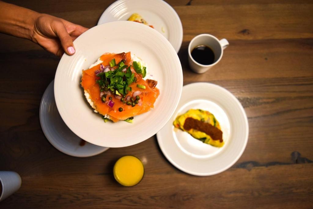 a person holding a plate of food on a table at Houston Airport Marriott at George Bush Intercontinental in Houston