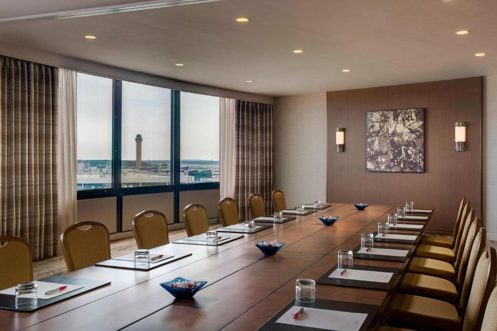 a large conference room with a long table and chairs at Houston Airport Marriott at George Bush Intercontinental in Houston